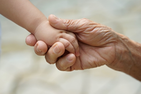 Grandparent and grandchild hold hands