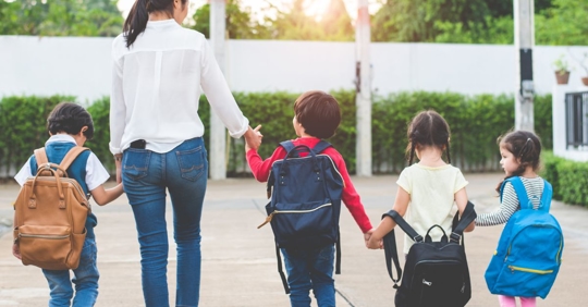 mother walking children back to school