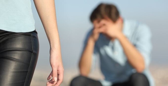 woman walking away from sad man