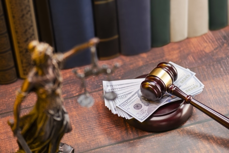 money and a gavel in a law office
