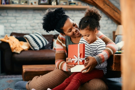 mother and daughter opening presents together
