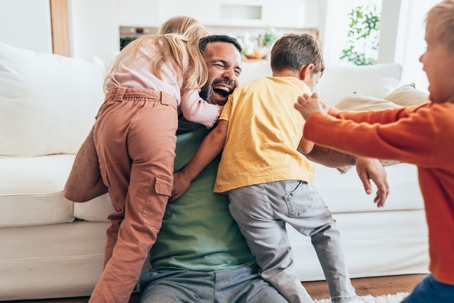 father playing with his children