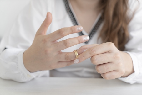 woman taking off wedding ring