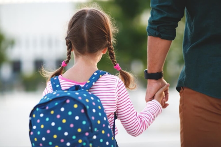 Dad and daughter holding hands