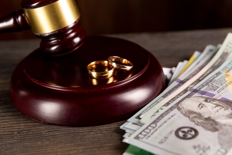 gavel with money and wedding ring