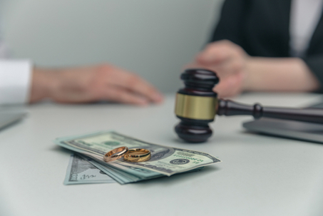 Legal alimony concept. Closeup view of wooden gavel and money.