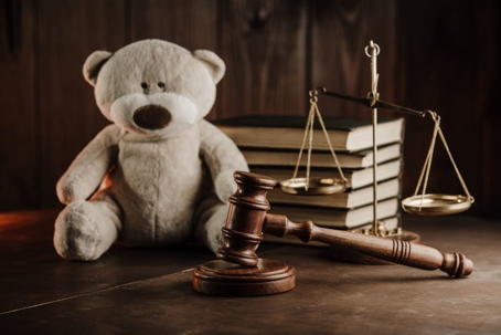 Wooden gavel and teddy bear
