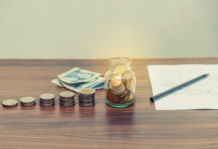Bill and stack of coin on business office table vintage style, Save money, save power and energy, income and revenue concept