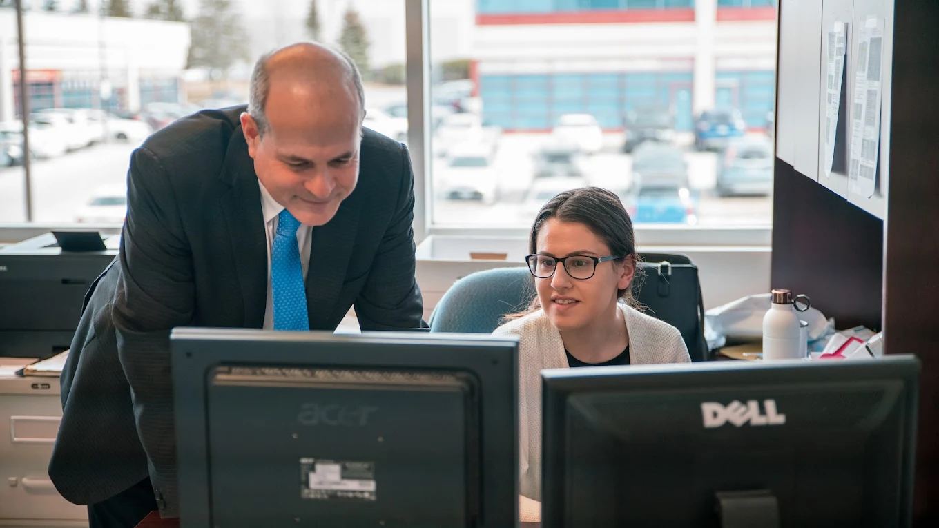 Andrew Feldstein working at a desk with an associate at the Vaughan office